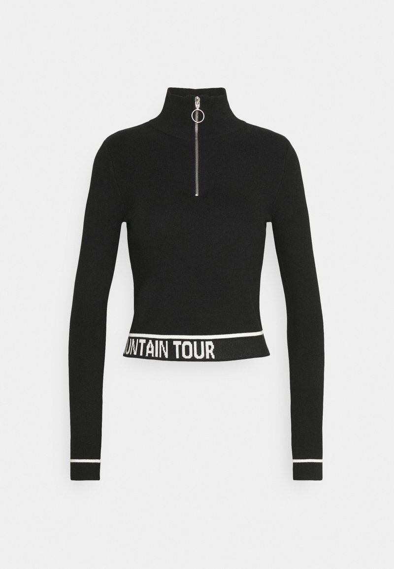 Pull slim noir à manches longues avec col montant zippé, texte blanc "MOUNTAIN TOUR" sur l'ourlet inférieur et bordure blanche aux poignets.