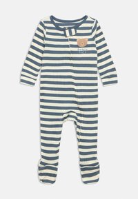 Tutina per neonato a righe blu e bianche con piedi, con zip frontale e patch di un orsetto con la scritta "Beary cute" sul petto.