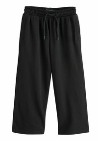 Schwarze, knie-lange Sportshorts aus weichem Material. Mit elastischem Bund und Kordelzug sowie Seitentaschen. Glatte Textur.