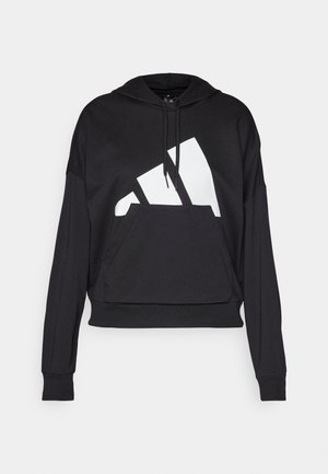 Black hooded sweatshirt with a large white logo and front kangaroo pocket. Features long sleeves and ribbed cuffs. Soft material.