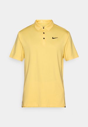 Yellow polo shirt made of soft fabric, featuring a classic collar, three buttons, and a small black Nike logo on the left chest.