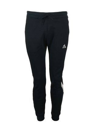 Pantalones de chándal de color azul marino oscuro, hechos de una mezcla de algodón, con una cintura elástica y cordón, puños ajustados y un pequeño logo en la parte delantera.