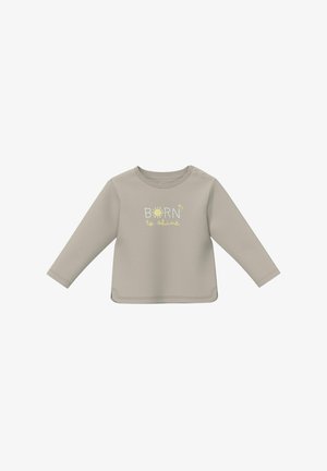 Chemise bébé beige clair à manches longues avec boutons-pression sur l'épaule, ornée du texte jaune et blanc « Born to shine » et d'un graphique de soleil sur le devant.