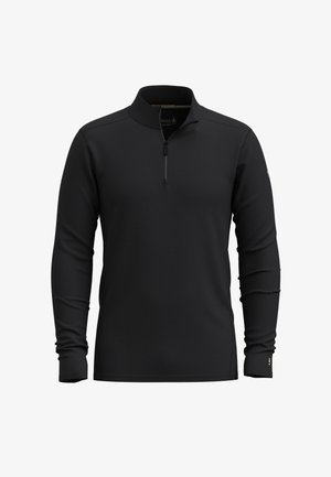 Musta pitkähiha-poolopaita pystykorkealla kauluksella ja puoliksi avattavalla vetoketjulla, esitetty edestä valkoisella taustalla.