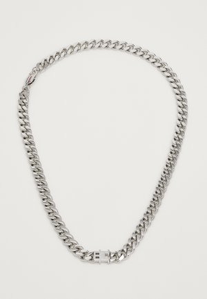 Silver chunky chain necklace with a rectangular clasp featuring an engraved design and a small striped detail near the clasp.