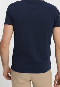 Navy blue cotton t-shirt with short sleeves, crew neckline, and smooth texture. Simple design with no visible patterns or accents.