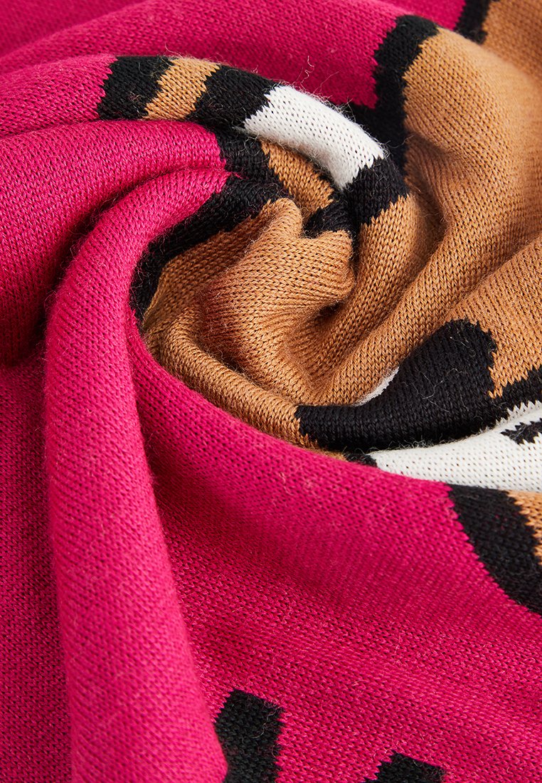 Strickstoff mit wirbelnden Mustern in Pink, Braun, Schwarz und Weiß. Sanfte Textur mit sichtbaren Garnstichen.