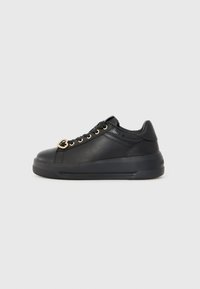 Black sneakers made of smooth leather with gold eyelets, a decorative heart-shaped accent, and a textured rubber sole.