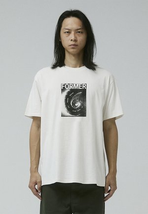 White cotton t-shirt featuring a black graphic print of the word "FORMER" and swirling design, with a relaxed fit and short sleeves.