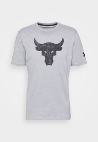 Harmaa puuvillapaita, jossa on suuri musta härkälogo edessä. Pyöreä kaula-aukko ja lyhyet hihat. Under Armour -logo hihassa.