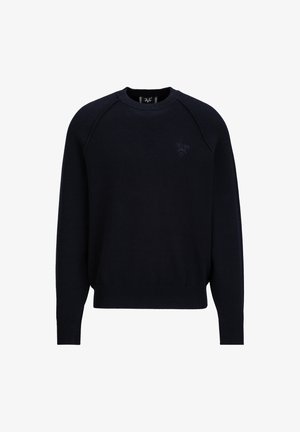 Marineblauwe crewneck sweatshirt met raglanmouwen, ribgebreide boorden en zoom, en een reliëf "1969" logo op de borst. Zachte textuur, casual pasvorm.