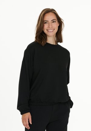 Schwarzes Pullover mit Rundhalsausschnitt, langen Ärmeln und elastischem Saum. Glatte Textur und lockere Passform, kombiniert mit passenden Hosen.