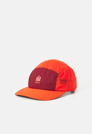 Red and orange lightweight running cap with a maroon panel, featuring a logo and text on the side, and a traditional curved visor.
