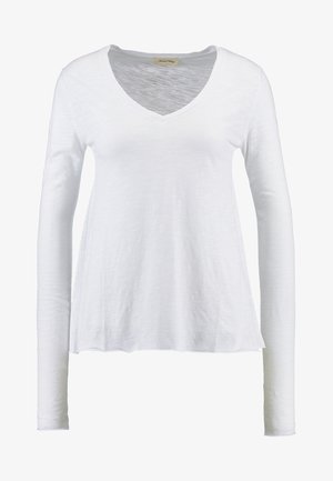 Witte lange mouw V-hals T-shirt gemaakt van lichtgewicht, gestructureerde stof met een ontspannen pasvorm en zijnaad voor extra val.