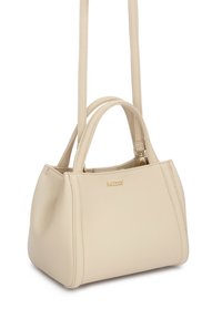 Smėlio spalvos odinė rankinė su dviem trumpomis rankenomis, nuimama ilga petneša ir auksiniu "kazar" logotipu priekyje, eksponuojama ant balto fono.