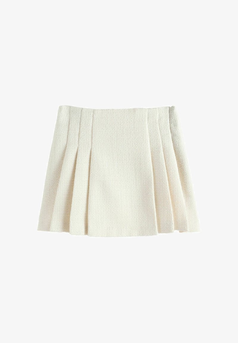 Jupe en tissu texturé plissé de couleur crème avec une silhouette évasée en A et une apparence douce et structurée.