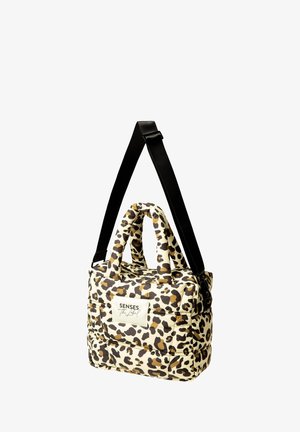 Leopard print handbag with padded exterior, two short handles, and a long adjustable black strap. Features a white label with text.