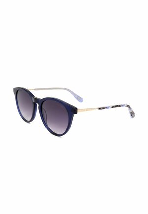 Occhiali da sole con lenti rotonde sfumate blu scuro, aste in metallo dorato e punte delle aste marmorizzate con motivo blu e bianco.