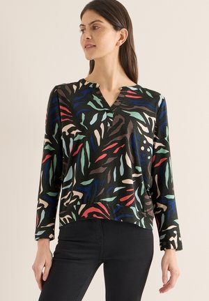 Svart topp med långa ärmar och ett färgglatt, abstrakt bladmönster i rött, blått, grönt och beige; har en V-ringning och en avslappnad passform.