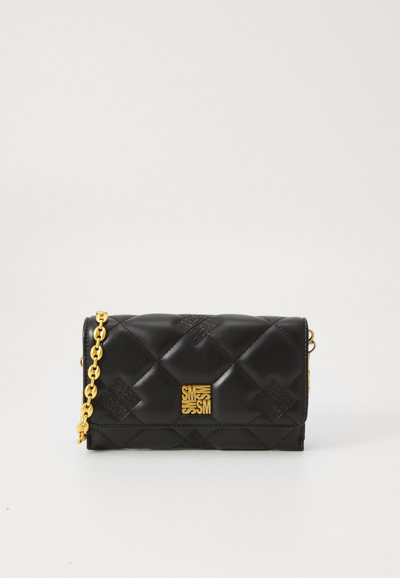 Black leather handbag with quilted texture, gold chain strap, and prominent gold square logo on the front. Compact rectangular shape.
