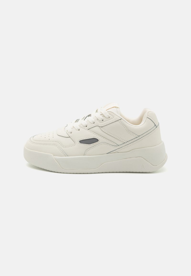 White leather sneakers with a textured surface, round toe, thick sole, and grey accents. Features lace-up design and perforated detailing.