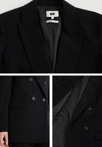 Blazer negro de doble botonadura con solapas de corte recto, botones y bolsillos laterales. Forro interior suave, diseño de corte recto, apariencia profesional.
