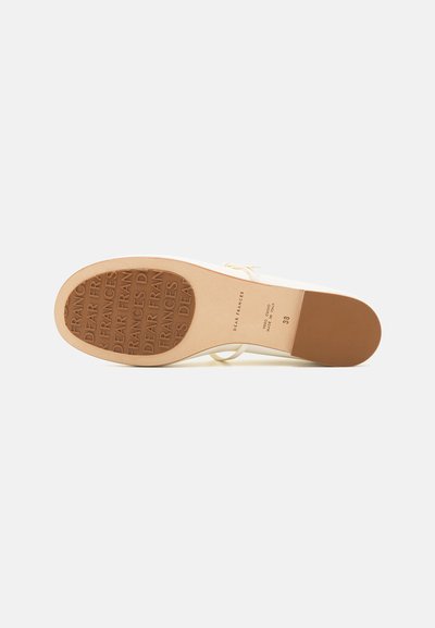 Beige high-heeled shoe with a smooth textured leather upper and a brown rubber sole featuring embossed brand name. Elegant silhouette with minimal design.