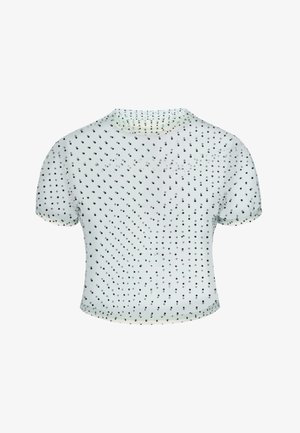 Witte kortere crop top met korte mouwen en kleine zwarte stippen gelijkmatig verdeeld over de stof.