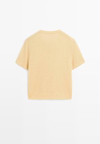 Short-sleeve, solid light yellow sweater with a smooth texture, ribbed hem, and raglan sleeves, showcasing a simple and clean design.