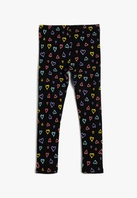 Leggings valmistettu joustavasta mustasta kankaasta, jossa on värikäs sydänkuvio pinkillä, sinisellä, keltaisella ja violetilla pinnalla.