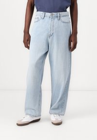 Light blue denim jeans with a relaxed fit, high waist, button closure, and five-pocket design. Features a faded finish and straight legs.