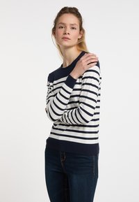 Maglione a righe in navy e bianco, con scollatura a girocollo e orlo a coste. Presenta maniche lunghe e una vestibilità rilassata, realizzato in un tessuto morbido.