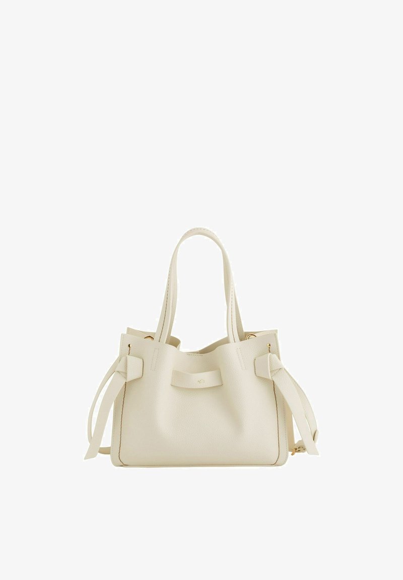 Krémově zbarvená kožená kabelka s dvěma uchy, bočními pásky a zlatými kovovými doplňky, zobrazena na bílém pozadí.