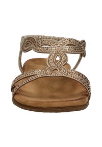 Sandals with a brown suede footbed, metallic gold straps embellished with crystals, featuring a decorative cut-out design and adjustable ankle strap.