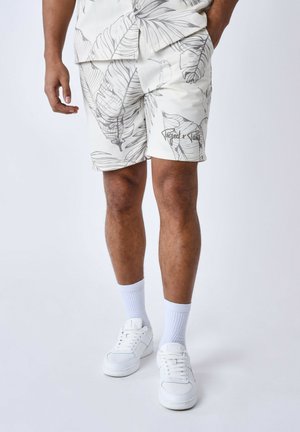 Pantalones cortos blancos con un patrón de hoja de palma en gris claro. Fabricados con un tejido texturizado, cuentan con bolsillos laterales y un detalle de logo en el dobladillo.