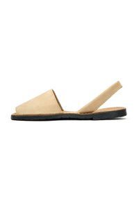 Beige leather slingback sandal with an open toe and a textured black rubber sole, featuring a minimalist design and curved edges.