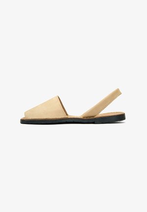 Beige leather slingback sandal with an open toe and a textured black rubber sole, featuring a minimalist design and curved edges.