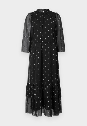 Vestido negro hecho de una tela ligera con mangas transparentes, que presenta lunares plateados y un dobladillo con volantes en capas. Cuello alto con fruncidos.