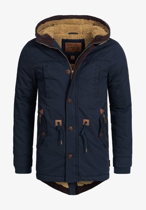 Marineblå parka-jakke med aftagelig hætte, brun fleecefor, detaljer i kunstlæder, frontlommer og justerbare snore.