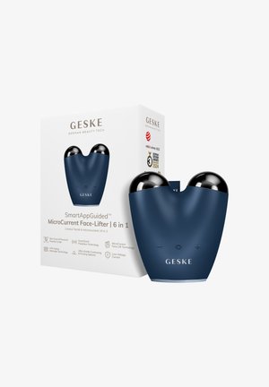 Appareil de lifting facial microcourant bleu et noir portable avec boutons plus, moins et marche à côté de sa boîte produit blanche avec marquage et icônes de récompenses.