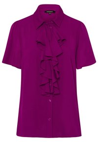 Bluzka z krótkim rękawem w jasnym fioletowym kolorze, z kołnierzykiem i falbanami z przodu. Posiada zapięcie na guziki oraz gładki, lekki materiał.