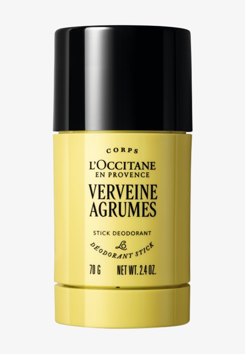 Déodorant stick jaune L'Occitane Verveine Agrumes avec bouchon noir, 70 g, 2,4 oz, étiqueté en texte noir.