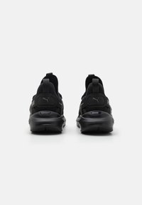 Schwarze Sportschuhe mit einem Obermaterial aus Mesh, gepolstertem Kragen und kontrastierender Markenkennzeichnung. Sie verfügen über eine robuste Gummisohle und Ziehhilfen für ein einfaches An- und Ausziehen.