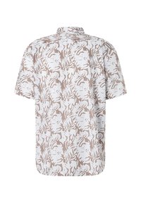 Camisa de manga corta en beige claro y blanca con un patrón de hojas; cuenta con un cuello de punta y un corte relajado. Tejido suave y ligero.