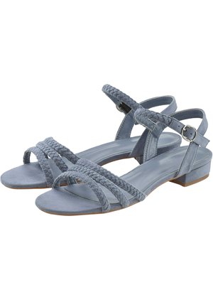 Blue suede sandals featuring braided straps, an ankle buckle, and a low block heel. Open-toe design with smooth detailing.