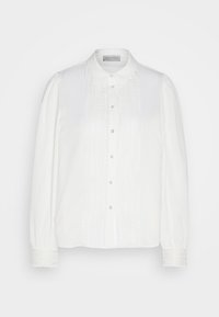 Blouse blanche à manches longues, avec un col et une fermeture à boutons sur le devant. Présente une bordure en dentelle décorative le long du centre et des manches. Tissu lisse.