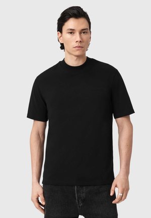 Schwarzes T-Shirt mit kurzen Ärmeln in entspannter Passform, aus glattem Stoff, mit Rundhalsausschnitt und dezentem Logodetail auf der Brust.