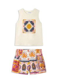 Cream sleeveless top with sun face graphic and multicolored zodiac sign patterned shorts in pink, orange, and blue tones.