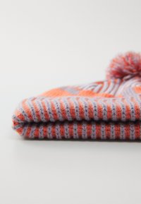 Gorro de malha em laranja e lavanda com textura canelada, apresentando um pom-pom em cima e riscas horizontais para detalhe visual.