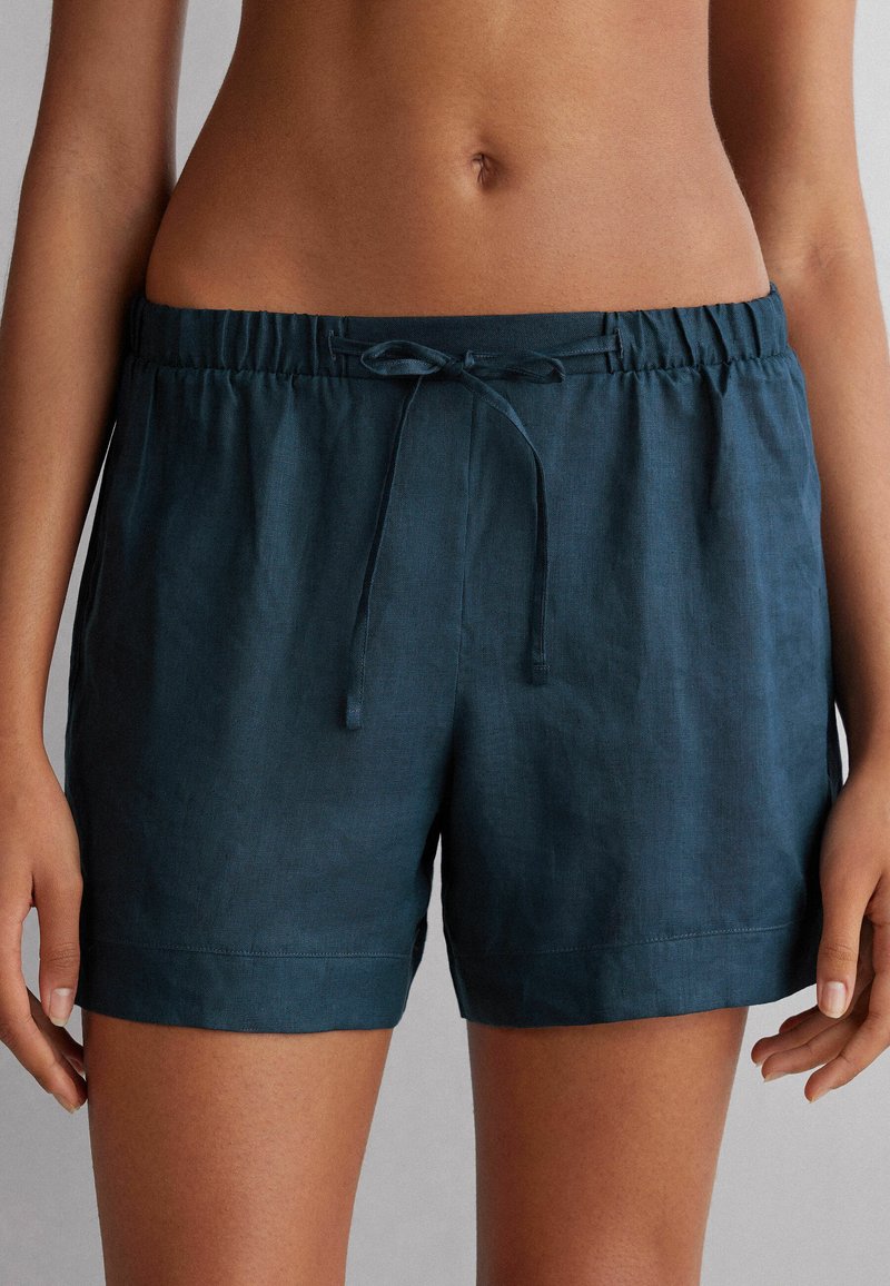 Mörk teal linnen shorts med elastisk midja och justerbar dragsko. Tyget har en slät yta och en avslappnad passform, med rena fållar.